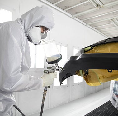 Collision Center Technician Painting a Vehicle | Pedersen Toyota in Fort Collins CO