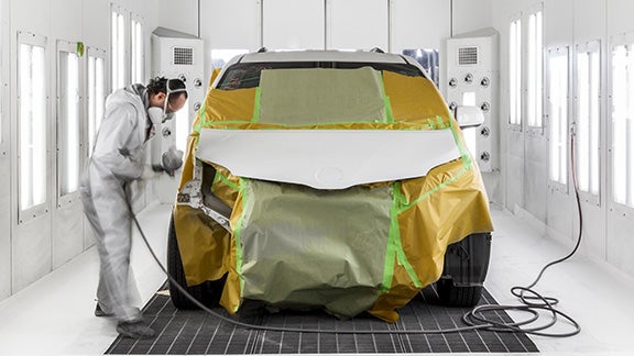 Collision Center Technician Painting a Vehicle | Pedersen Toyota in Fort Collins CO